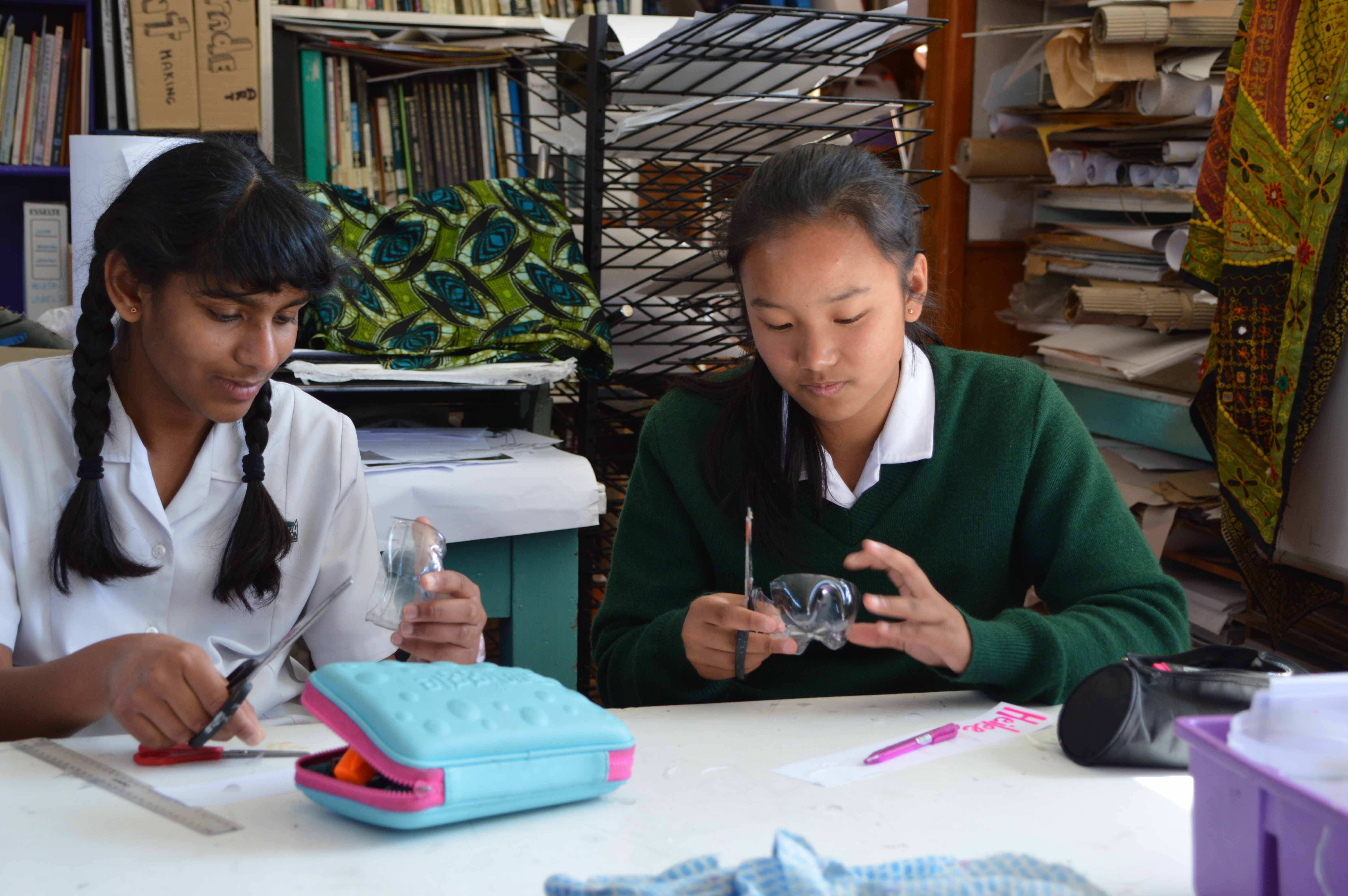 Two He Tīwai Mātauranga Heaton Normal Intermediate School female students at a desk with stationery